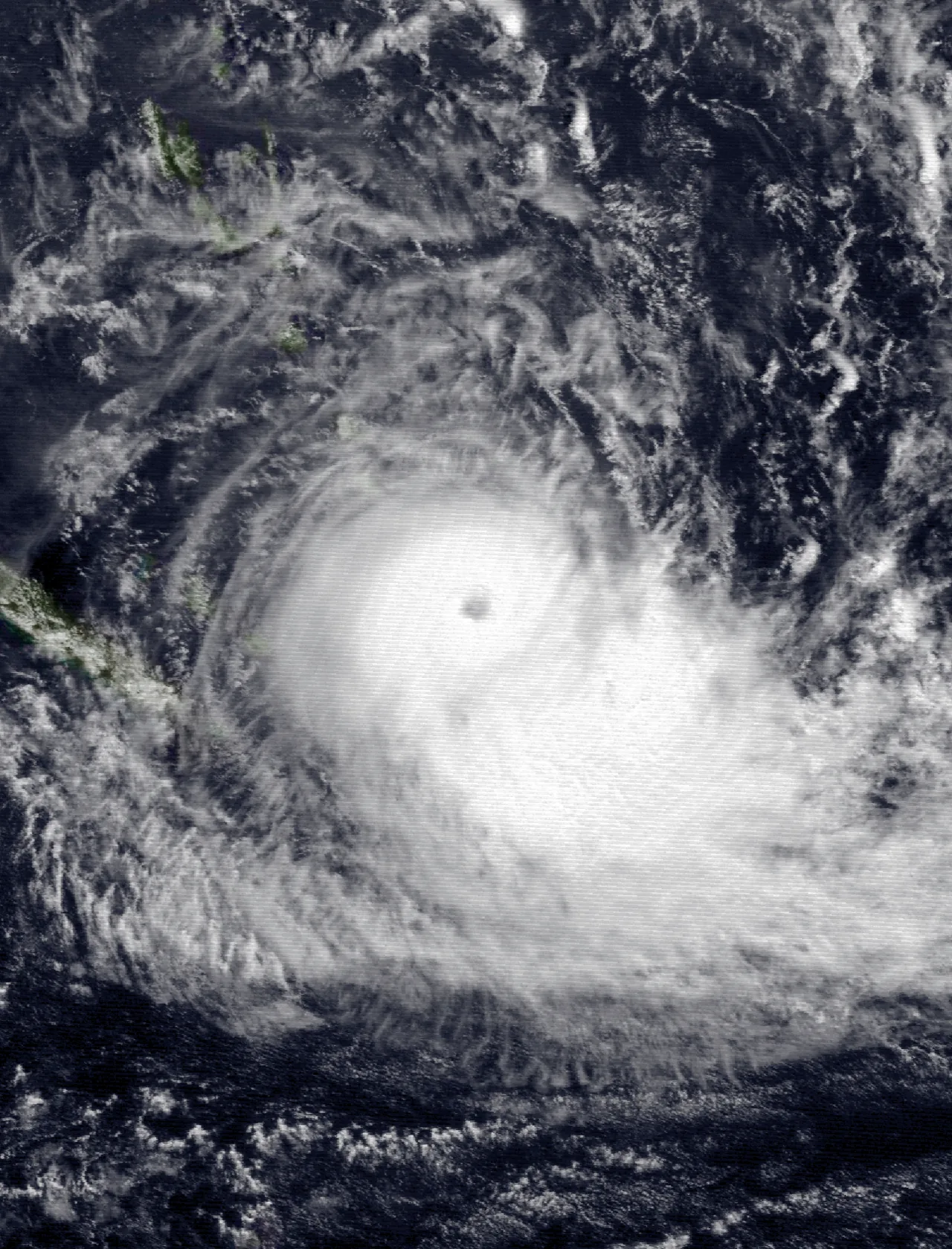 Processed and colorized Himawari 3 observation showing Cyclone Ivy’s broad spiral cloud structure over the ocean.