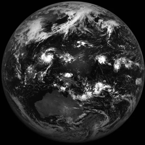 Grayscale full-disk Earth observation with Australia below center, Asia at upper left and extensive bright cloud systems against dark oceans.