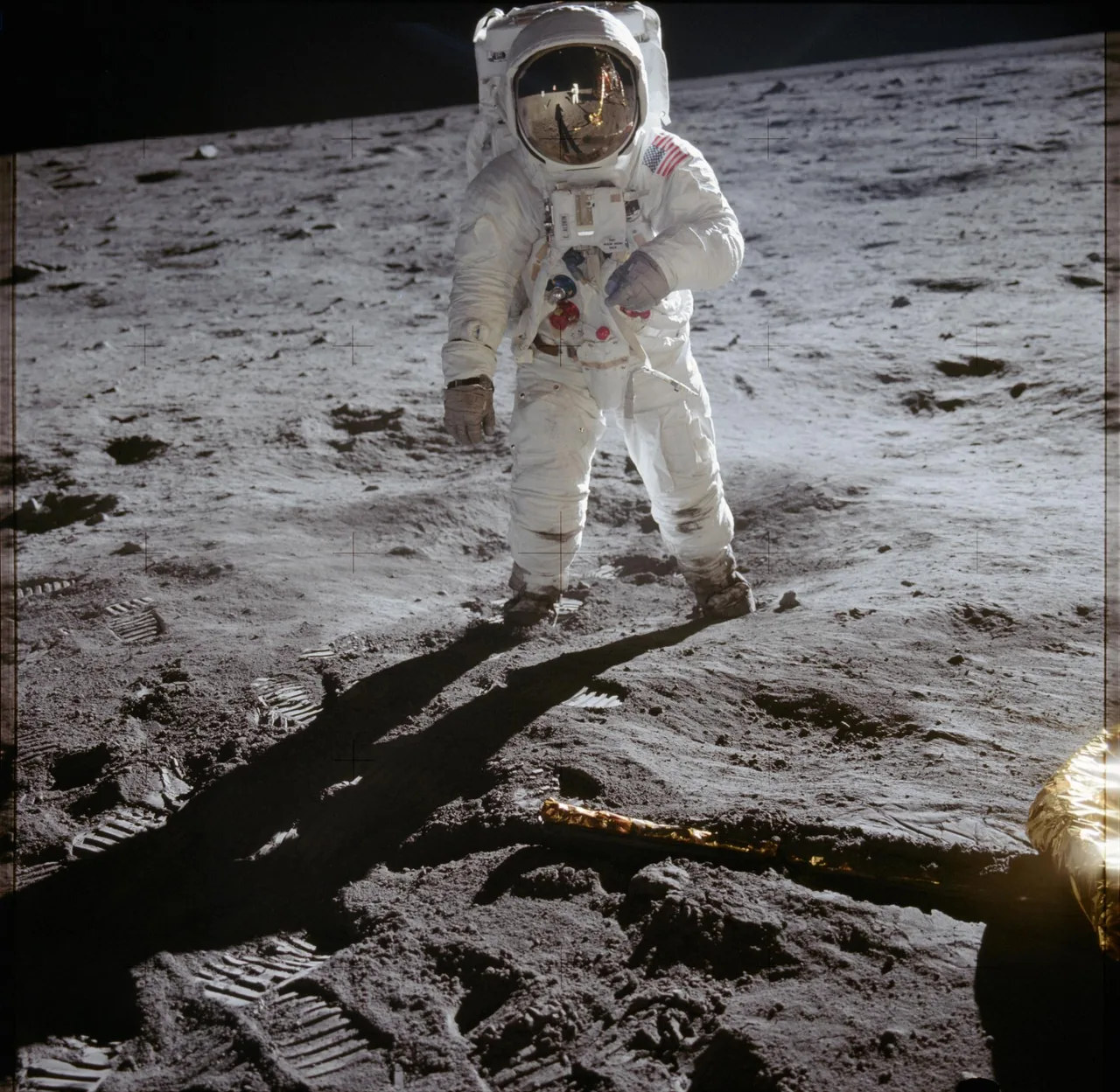 Buzz Aldrin stands on the Moon beside a landing leg of the lunar module Eagle