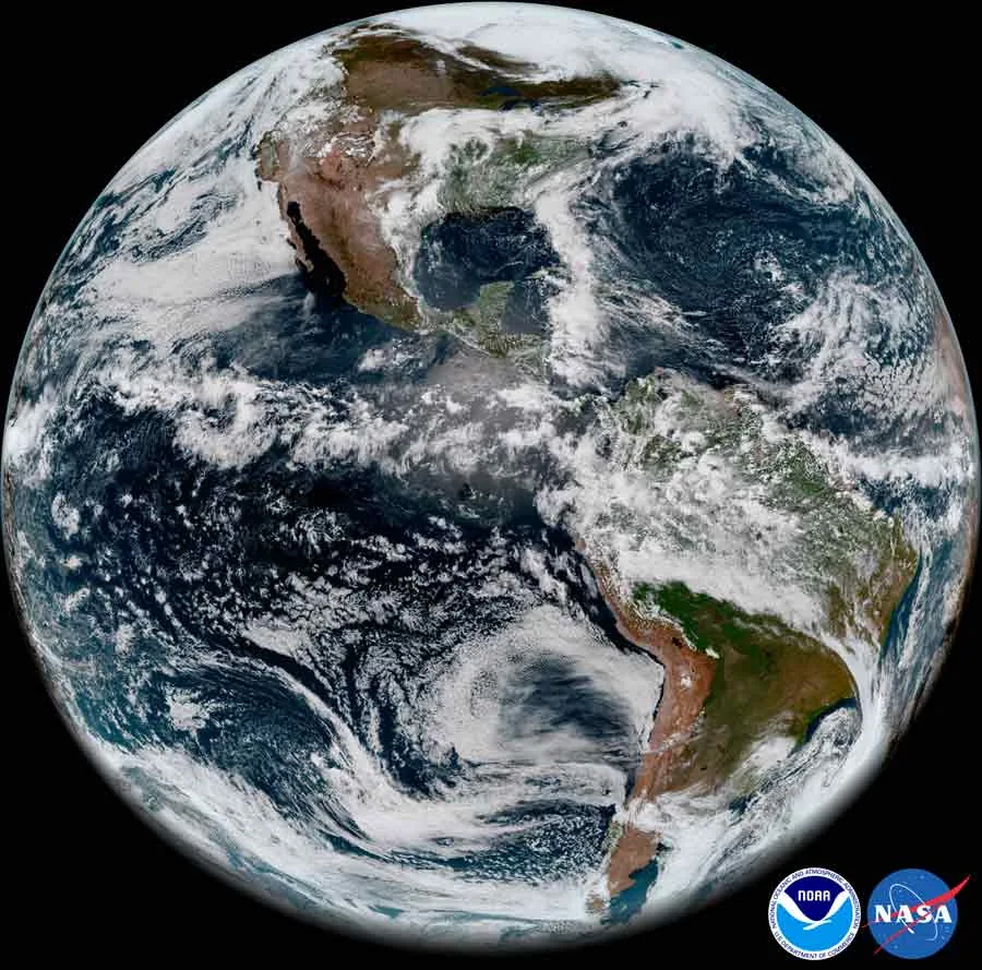A full Earth disk shows the Americas, blue ocean, and broad white cloud patterns against black space.