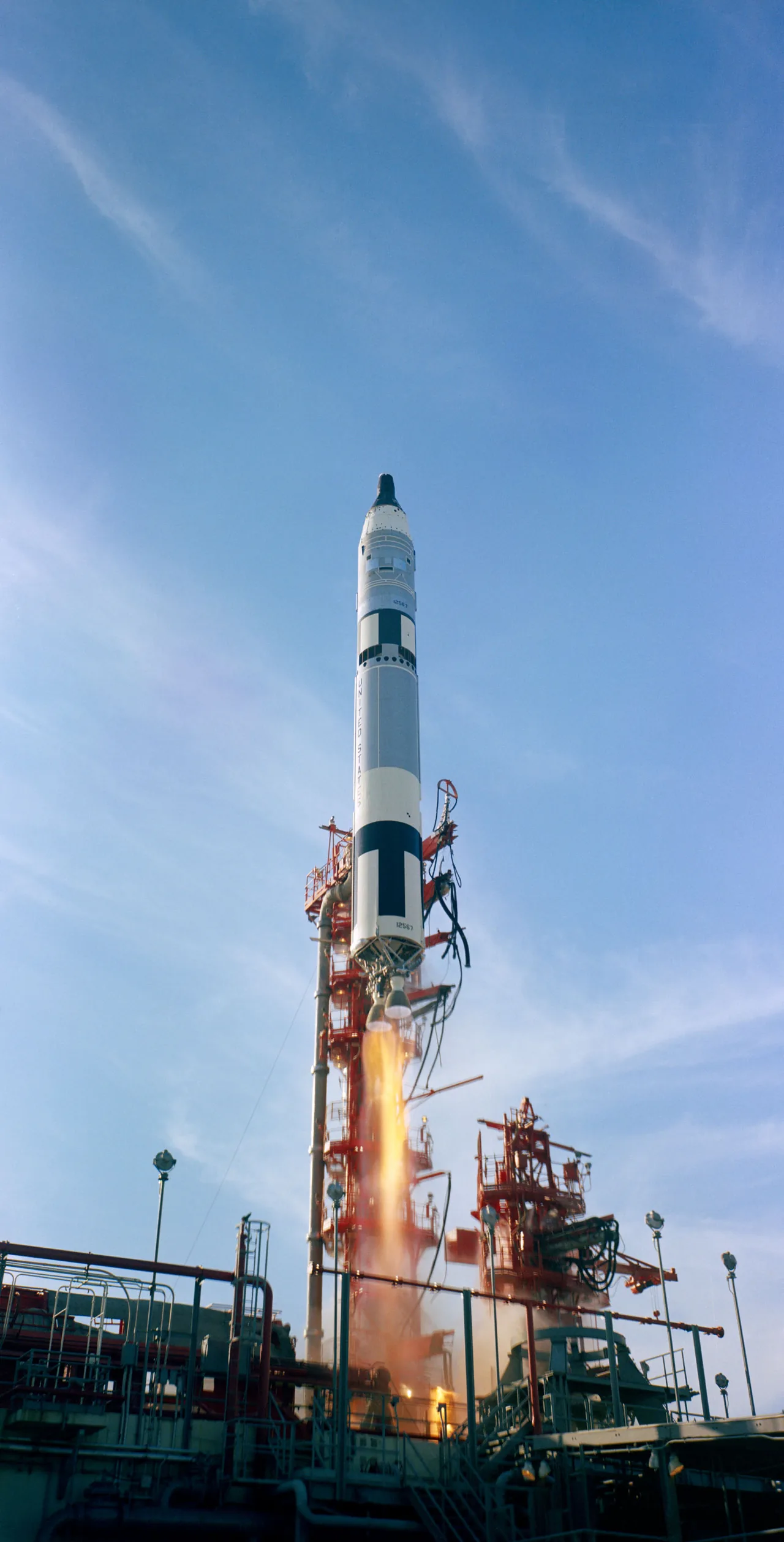A Titan II carrying Gemini XII lifts off beside a launch tower