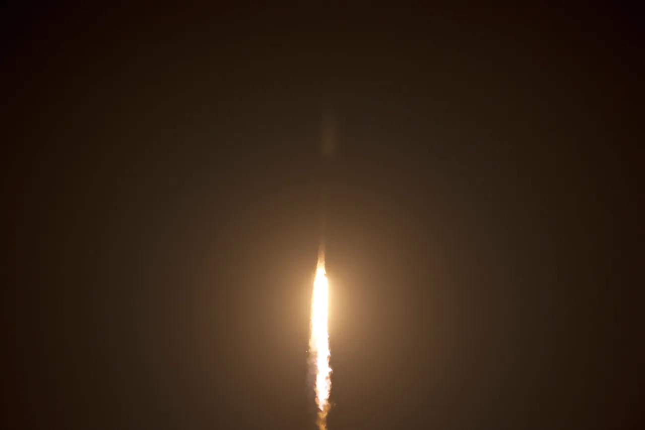 A bright, narrow Falcon 9 exhaust plume shines against a dark sky during the CRS-5 launch