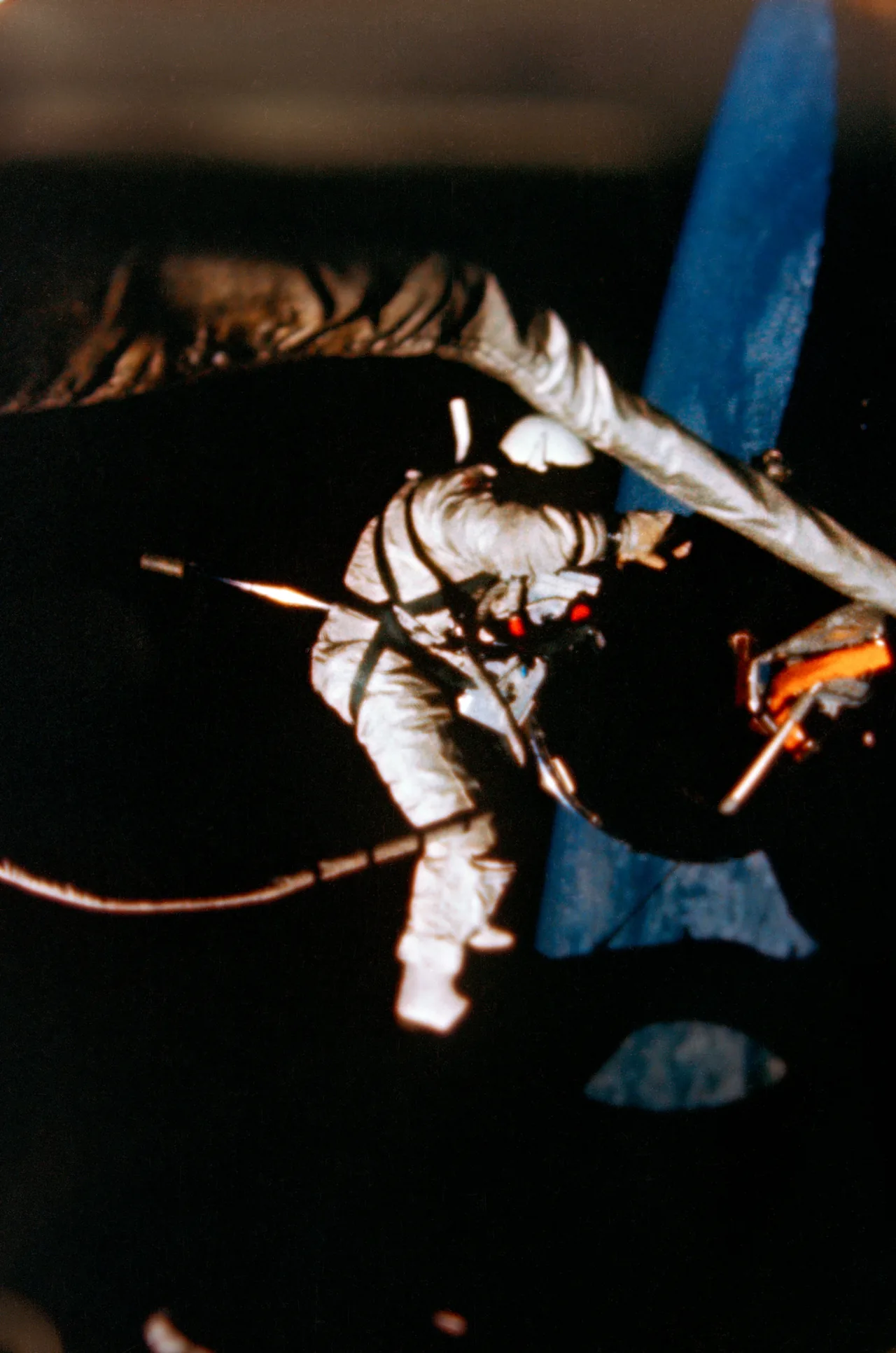 Buzz Aldrin working outside Gemini XII with tethered equipment