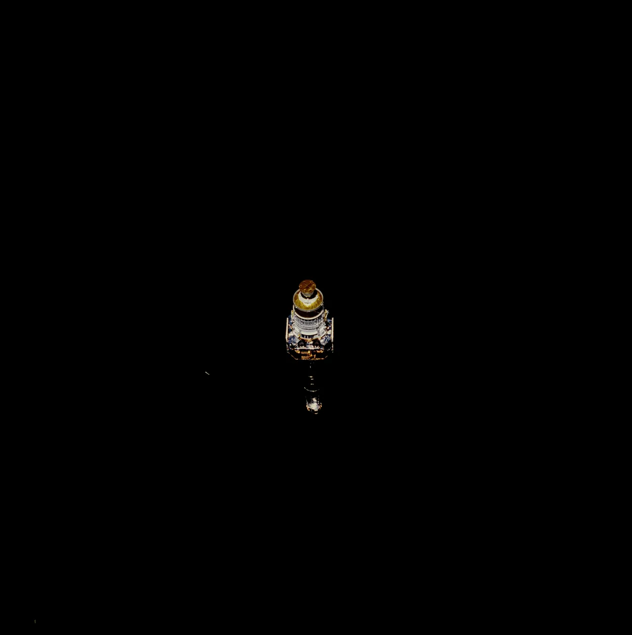 Chandra and its attached deployment hardware appear small near the lower middle of a broad black photographic frame.