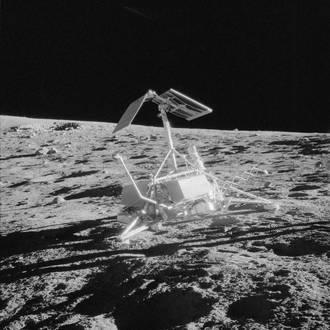 Surveyor 3 on the lunar surface, with its tall mast, landing legs, footpads, and sampler extending toward the right.