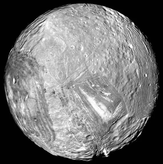 A grayscale view of Miranda shows craters and sharply contrasting ridged and grooved terrains
