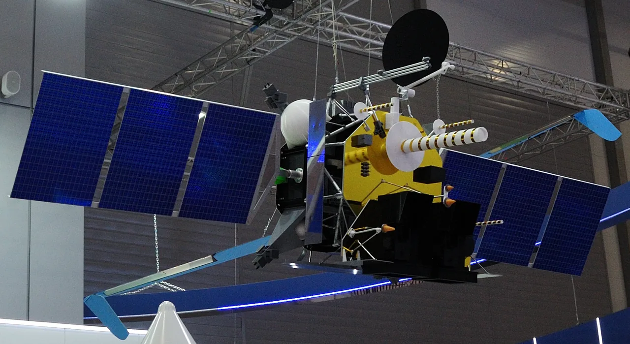 An Arktika-M exhibition model with two blue solar-array wings, a yellow-and-black central body and a large dish