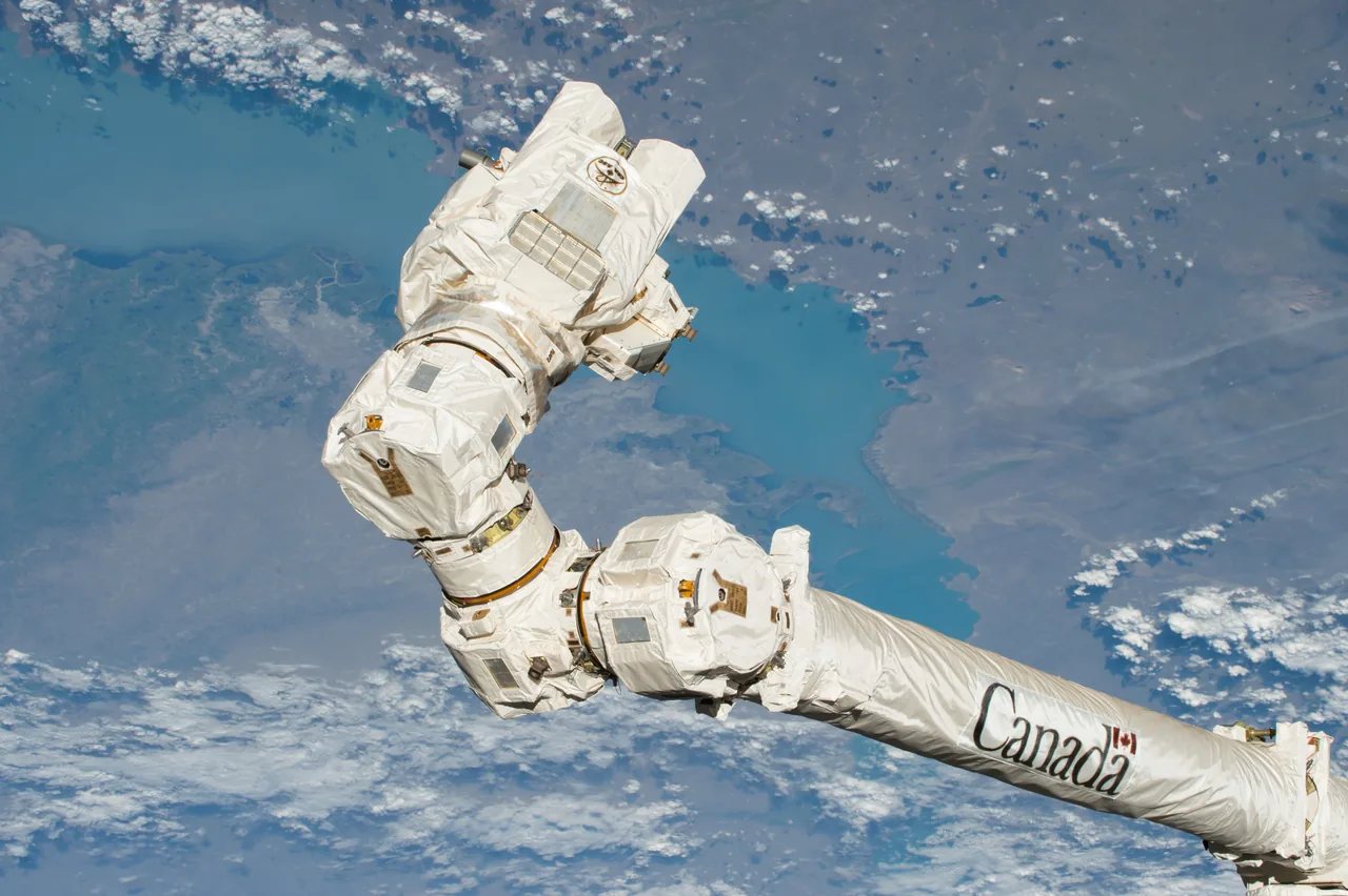 Canadarm2 end effector and wrapped wrist joints above Earth