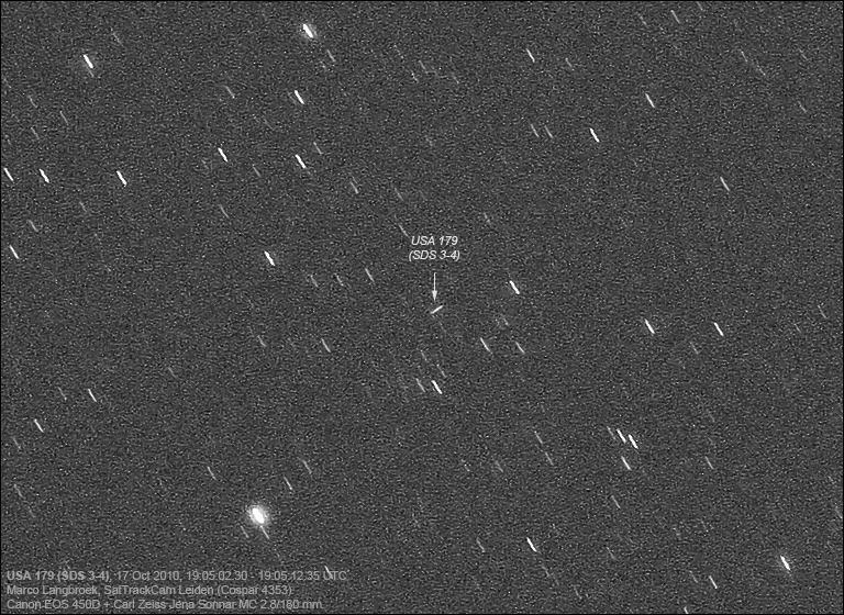 An annotated monochrome sky exposure marks a small USA 179 trail with an arrow and includes observing information below.