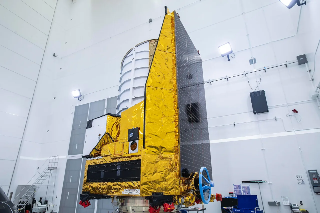Euclid in a cleanroom, with its white telescope enclosure above the instruments and dark solar panels along the right side.