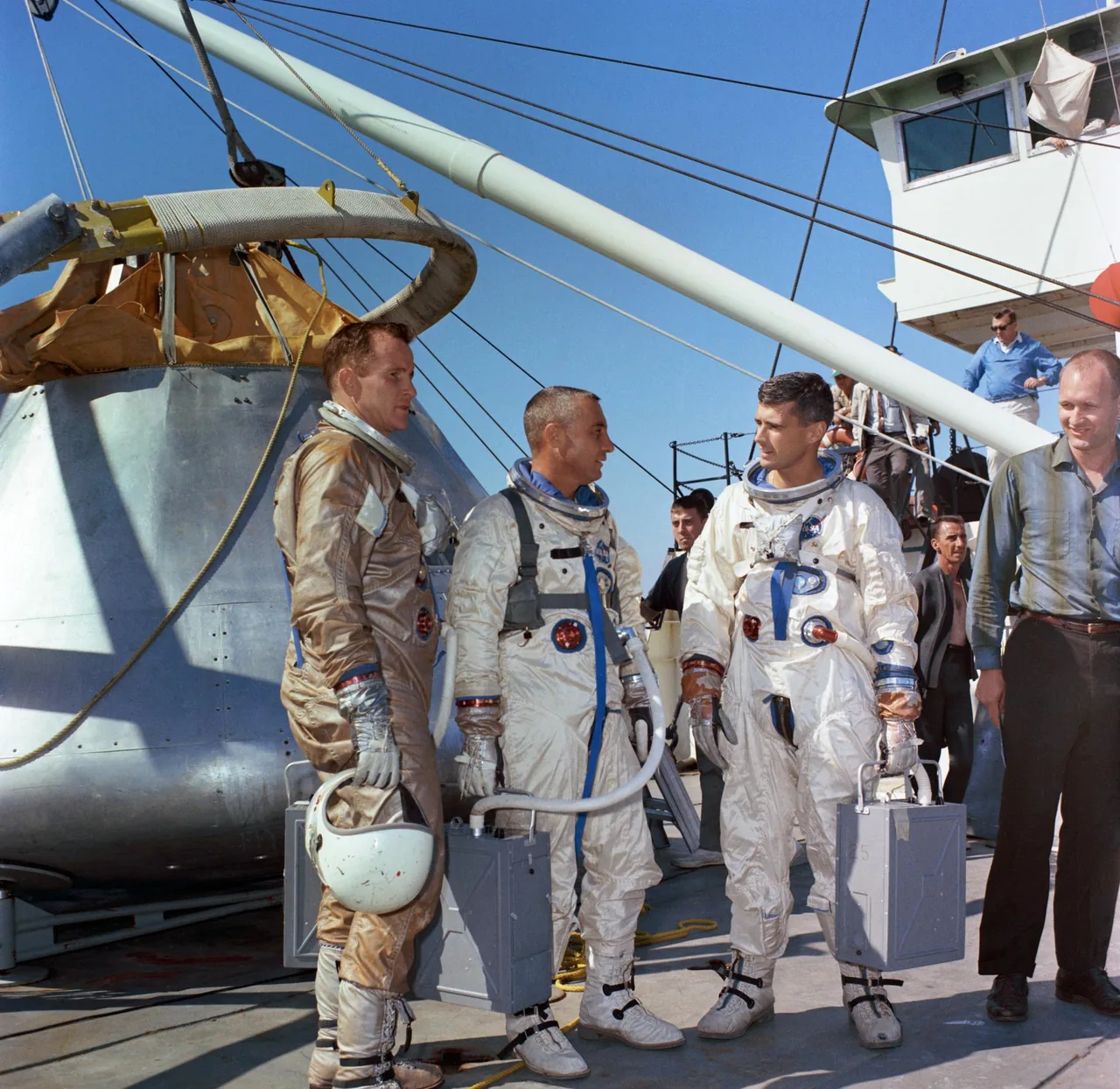 Ed White, Gus Grissom, and Roger Chaffee in spacesuits aboard NASA’s Retriever