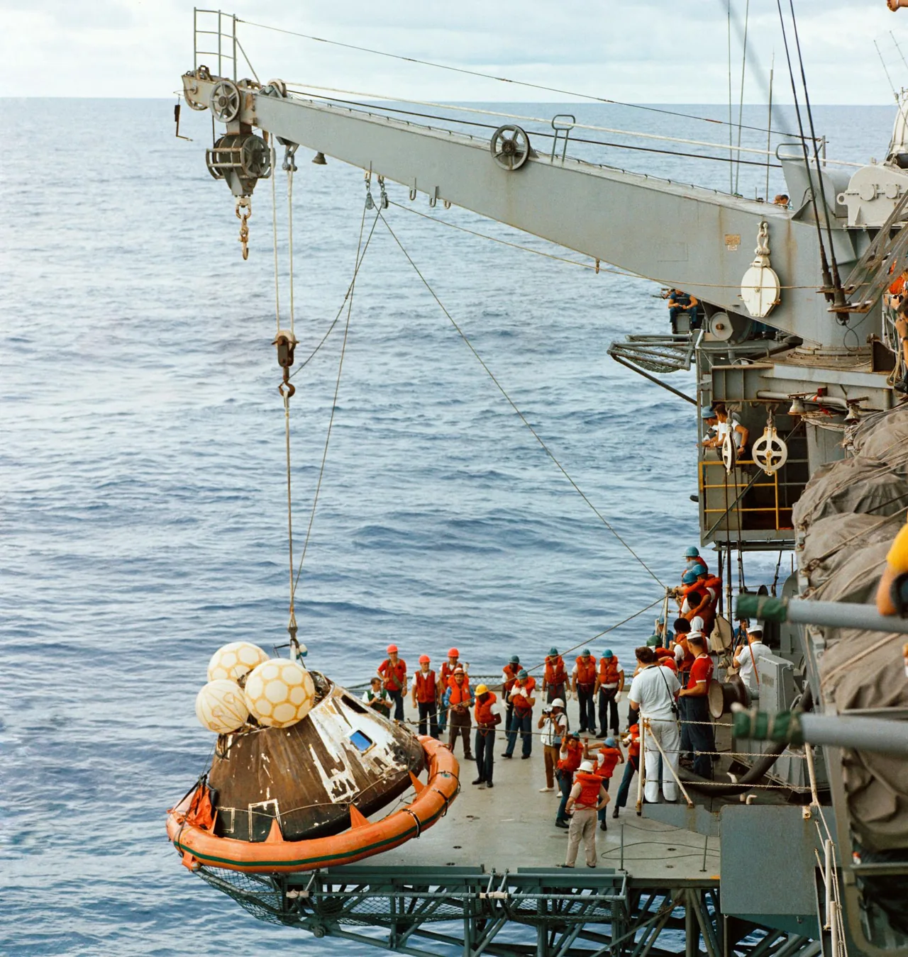 Sailors hoist Apollo 13’s command module aboard the recovery ship USS Iwo Jima