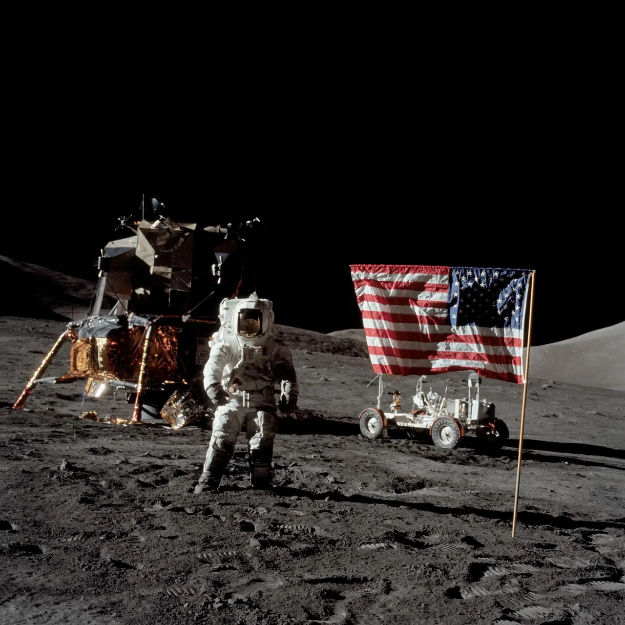 Harrison Schmitt on the Moon with Apollo 17’s lunar module to the left and its rover partly visible to the right