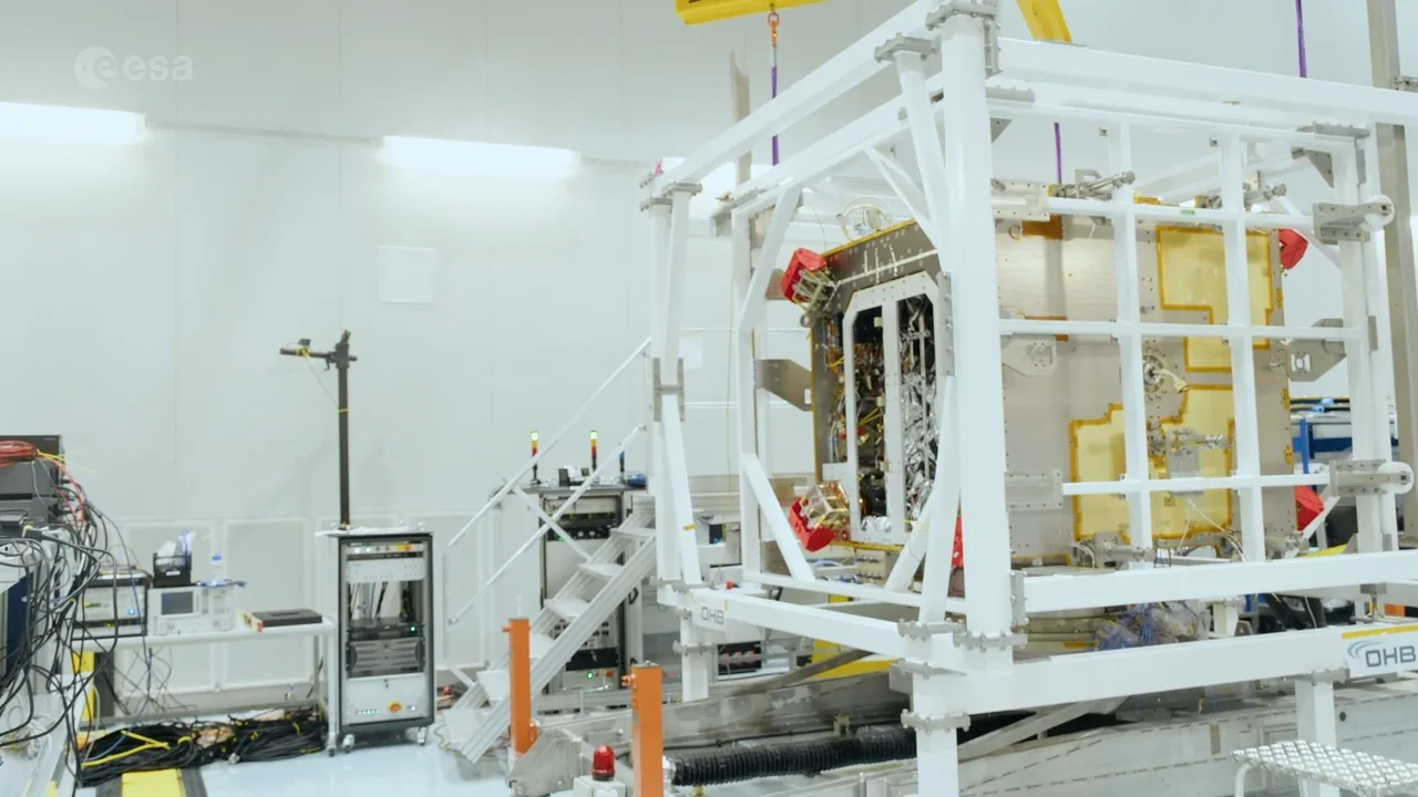 Hera’s integrated body sits inside a white handling frame with gold insulation and an open electronics bay visible