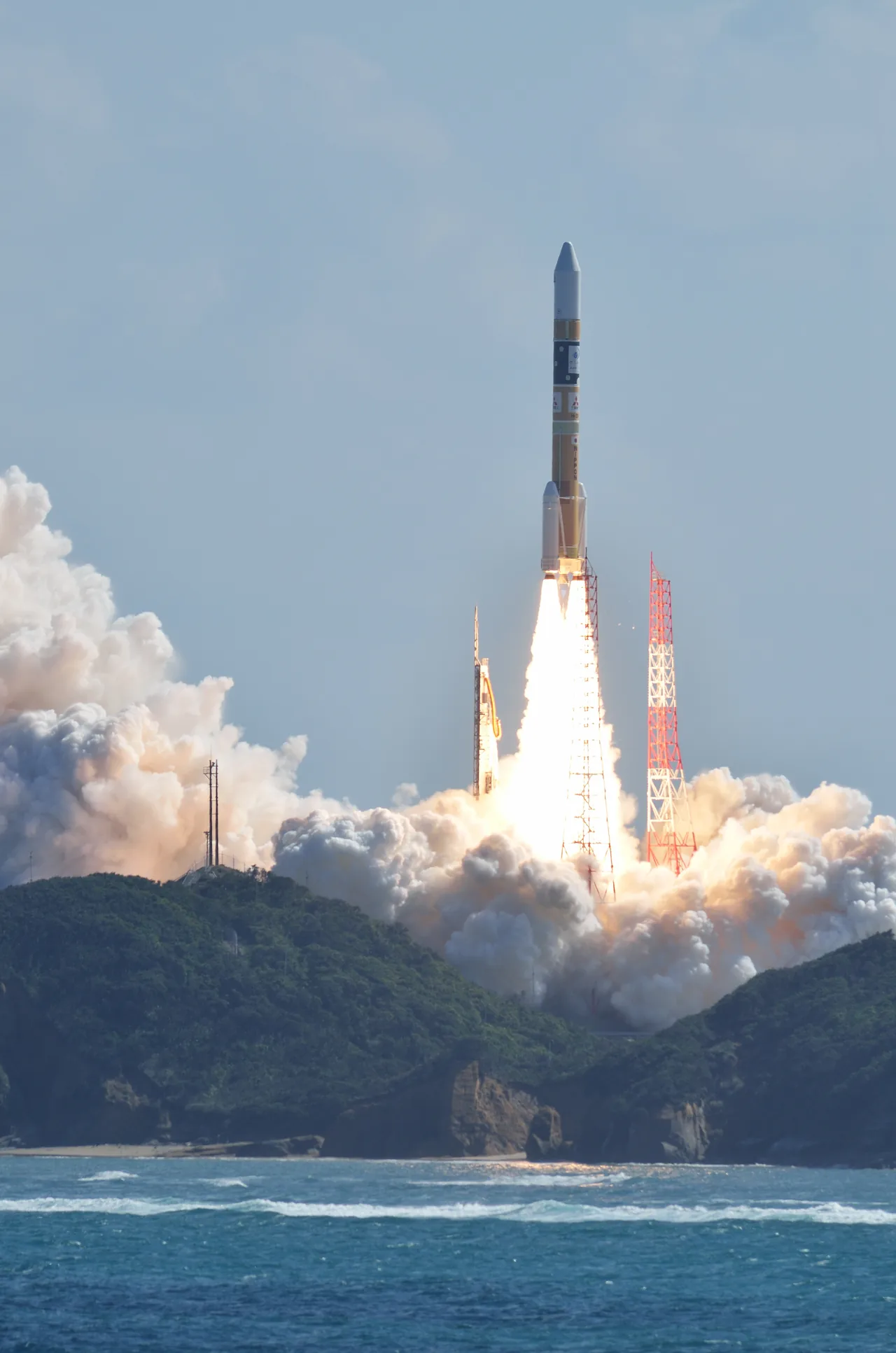 H-IIA Flight 25 climbing through a cloudy sky while launching the Himawari-8 weather satellite.