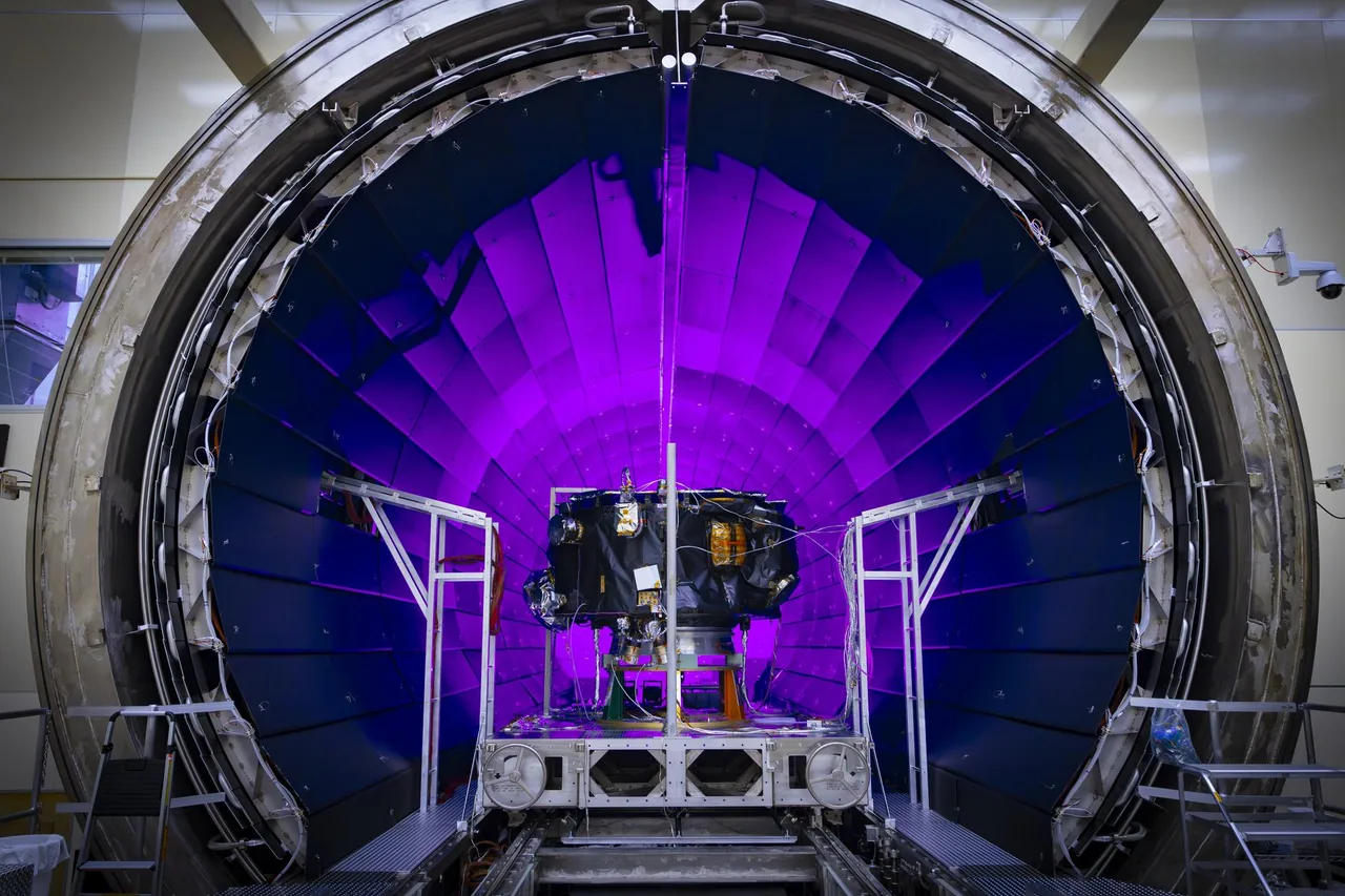 IMAP sits inside a round test chamber, surrounded by support hardware and cables under purple lighting.