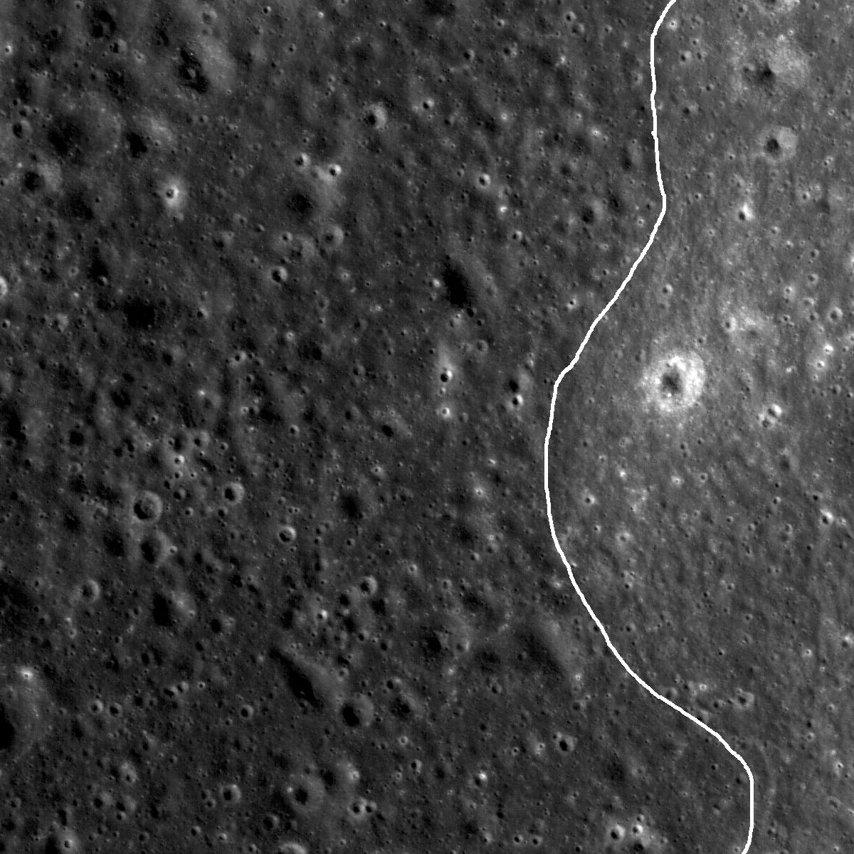 Grayscale lunar terrain with darker mare material at left, brighter highlands at right, and a white curve annotating their generalized contact.