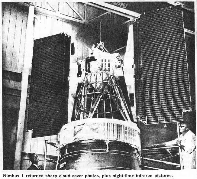 Nimbus 1 stands indoors with two broad rectangular solar panels beside its open structural frame