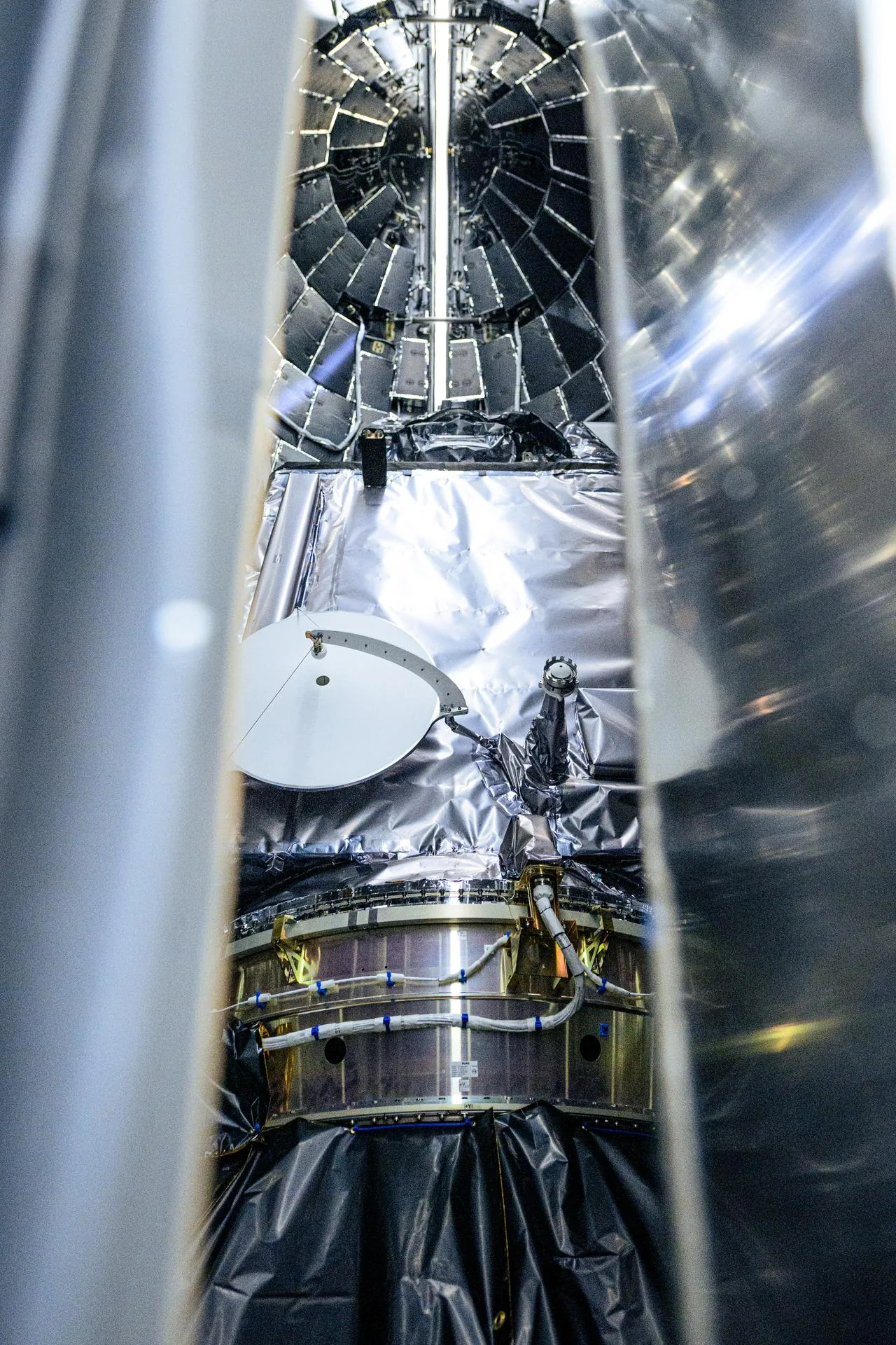 The foil-covered PACE spacecraft is visible between the open halves of its protective payload fairing