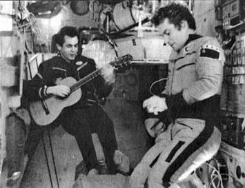 Ivanchenkov plays the Progress 3-delivered guitar aboard Salyut 6 beside Kovalyonok