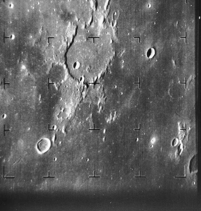 Grayscale Ranger 7 view of Guericke crater and nearby lunar terrain, with a regular grid of dark camera reference marks.