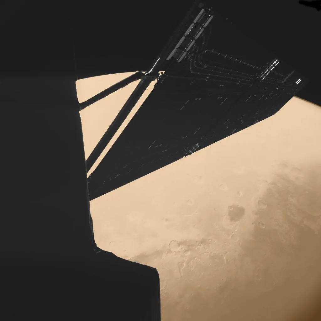 A dark spacecraft solar wing crosses the curved, tan limb of Mars