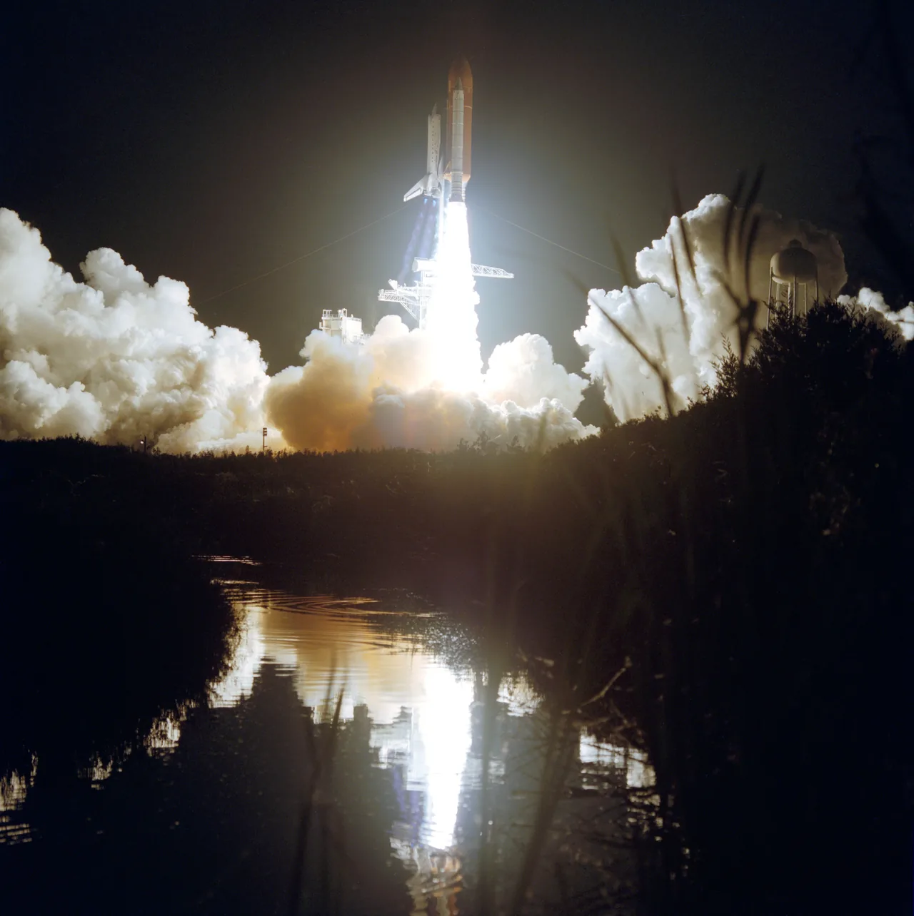 Space Shuttle Atlantis rises from its launch pad on STS-44 above a bright exhaust plume and rolling smoke