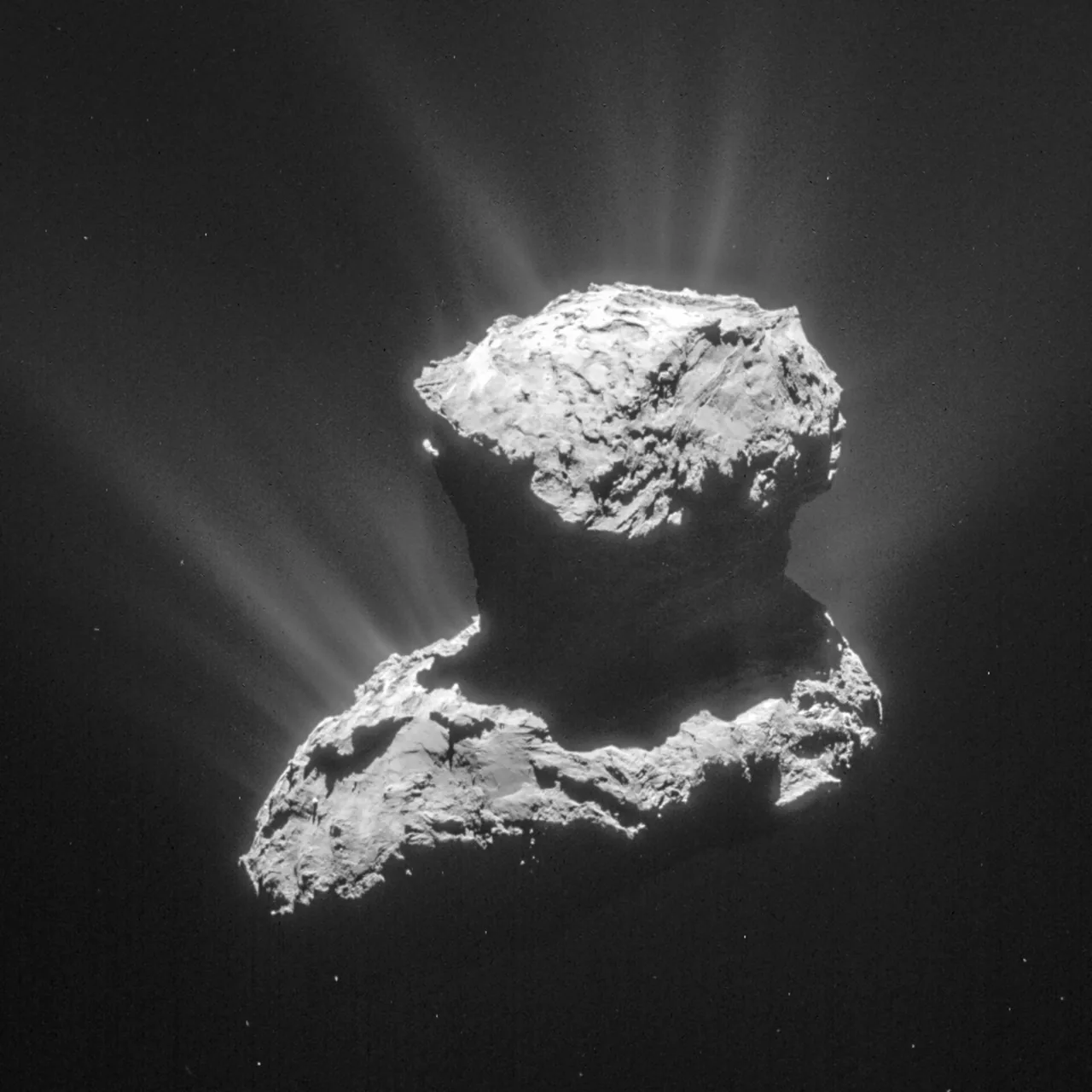 Comet 67P’s irregular two-lobed nucleus with bright dusty streams extending into space
