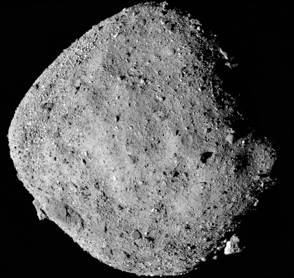 Bennu’s rough, boulder-covered shape is illuminated against black space in a spacecraft mosaic.