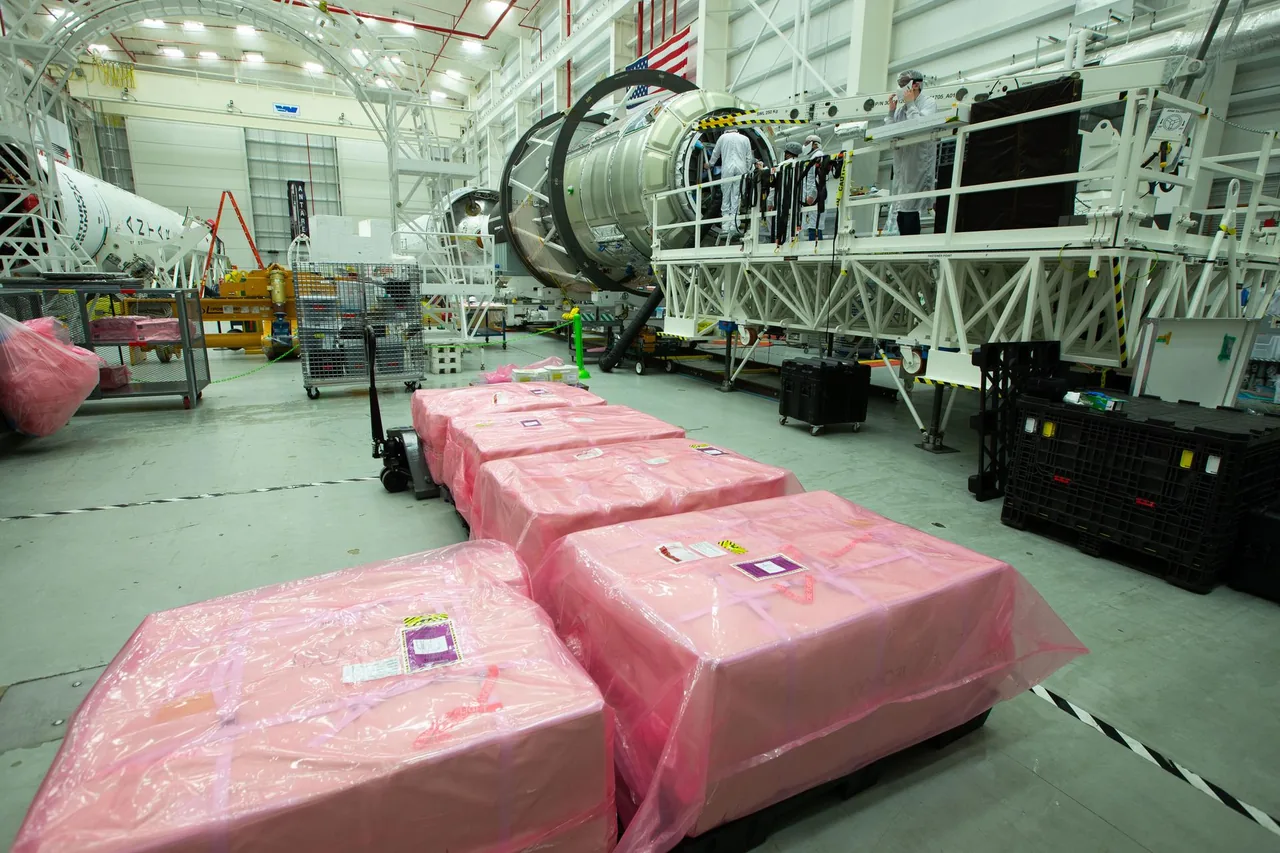 Technicians load science payloads into the exact Cygnus NG-15 cargo spacecraft before launch