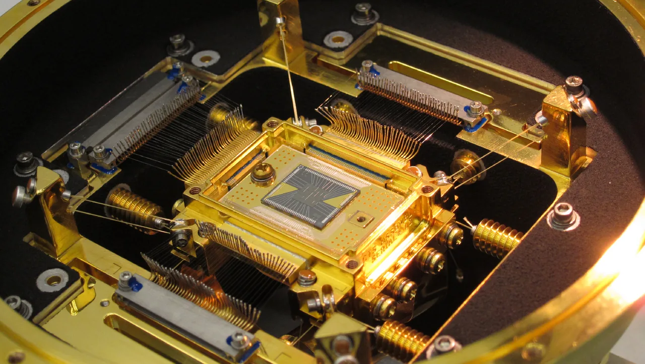 Hitomi’s small square microcalorimeter detector surrounded by fine wiring and gold-toned support hardware