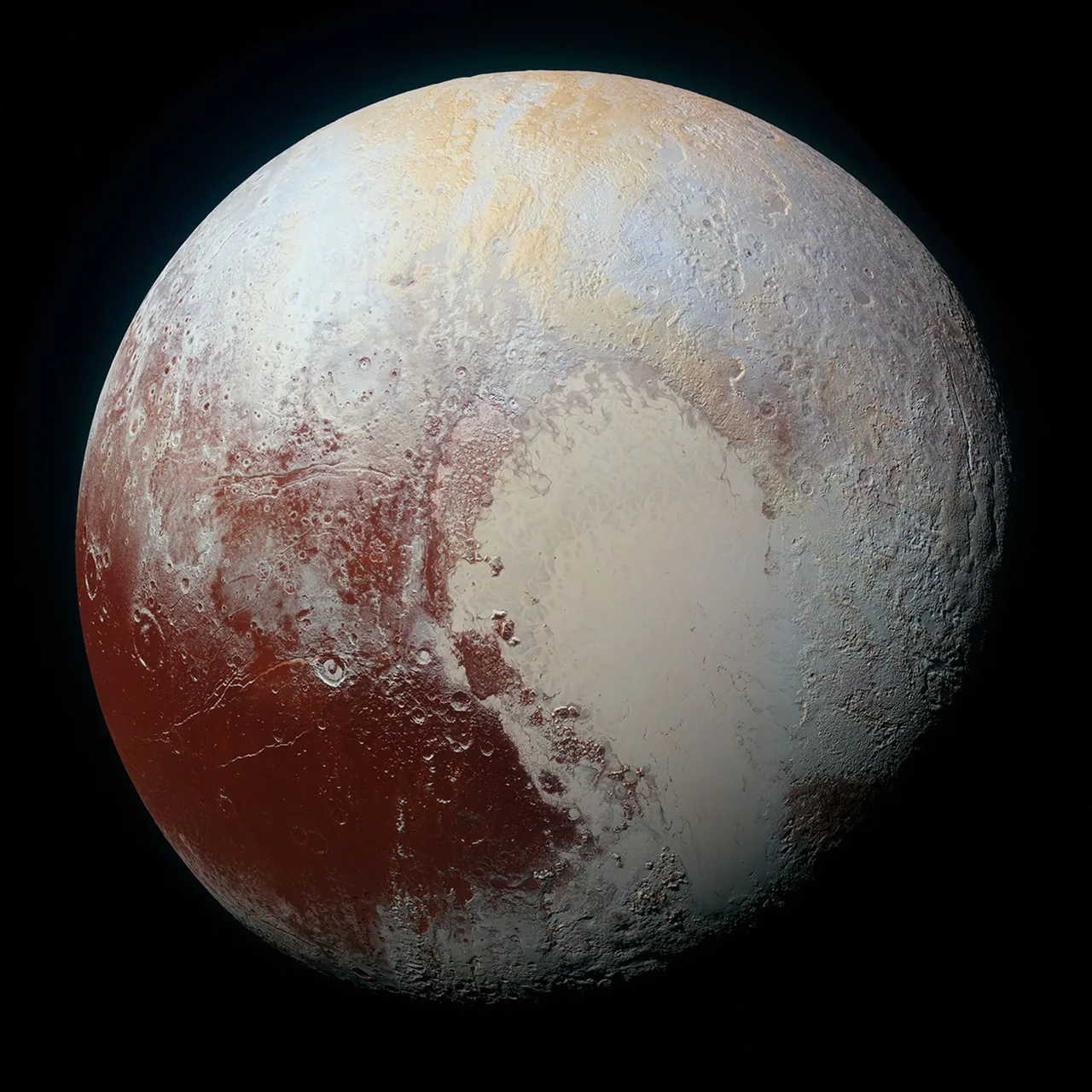 An enhanced-color New Horizons view of Pluto, including a bright heart-shaped region and surrounding darker terrain