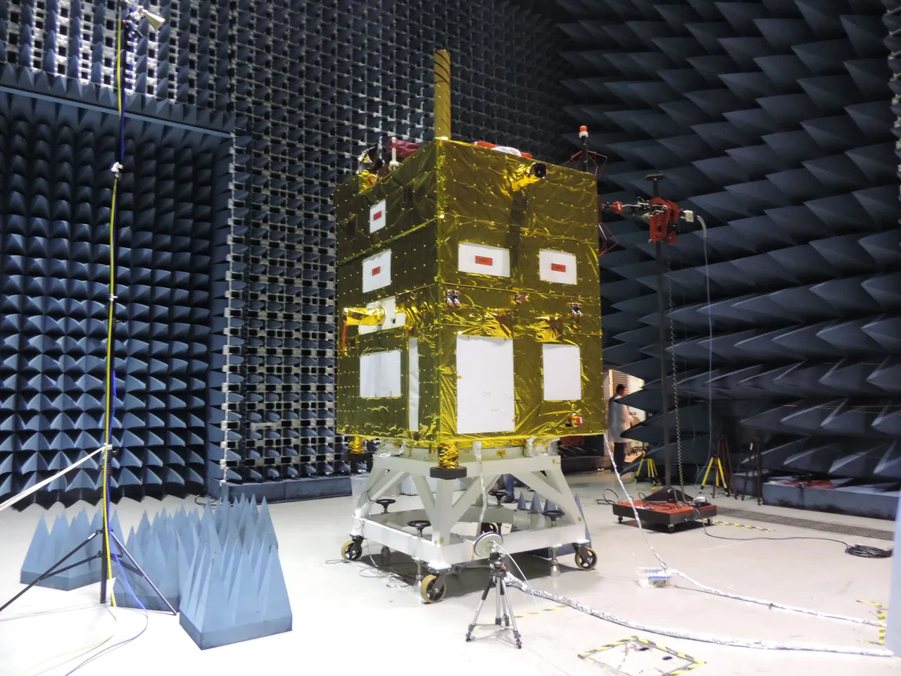 Gold-foil-covered CBERS-4A spacecraft standing in an antenna-test chamber before launch.