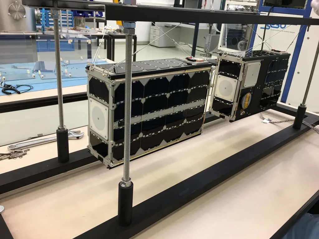 GOMX-4A at left and GOMX-4B at right suspended in a laboratory fixture