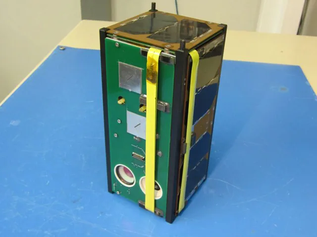 ANTELSAT 2U CubeSat resting on a blue work surface before launch.