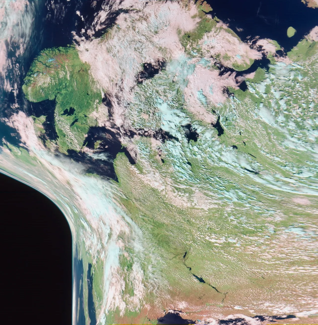 A processed satellite view of Europe and surrounding seas with clouds, green land and curved swath edges