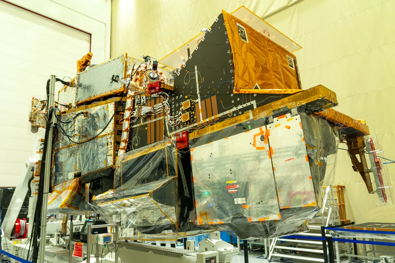 Large gold-and-silver Metop-SG A1 spacecraft with visible instrument structures in an assembly facility