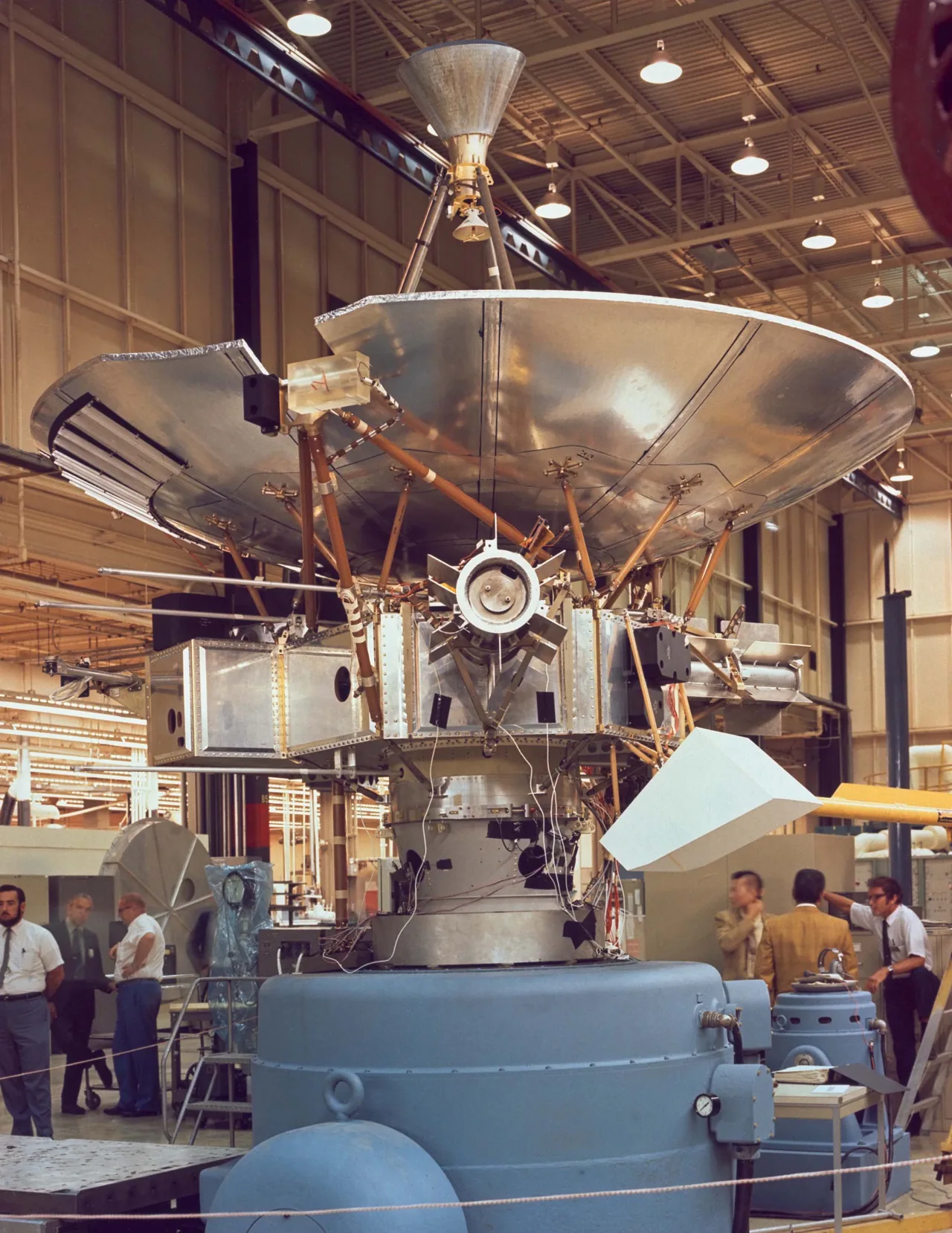 Pioneer 10’s large dish and instrument structure stand above ground equipment in an assembly building