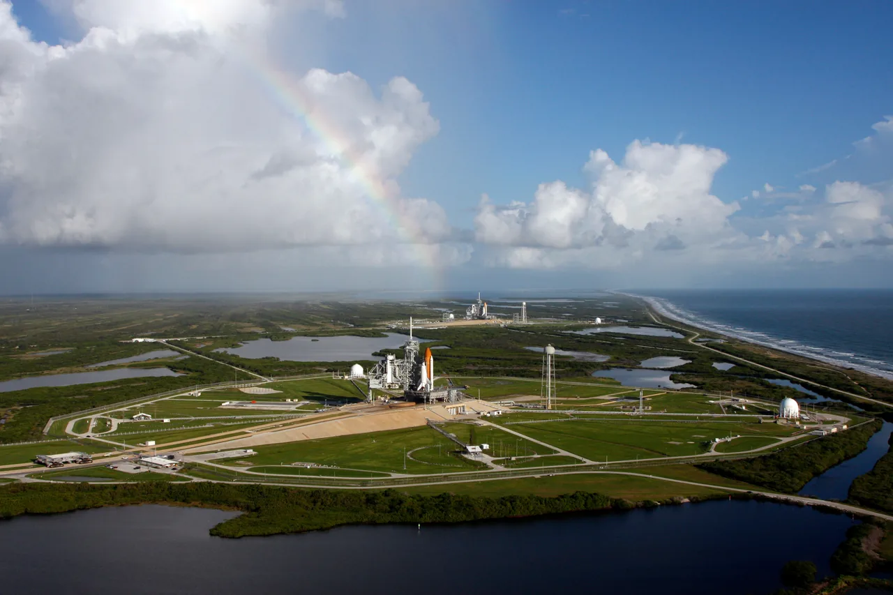 A rainbow above two Space Shuttle stacks on neighboring Kennedy Space Center launch pads
