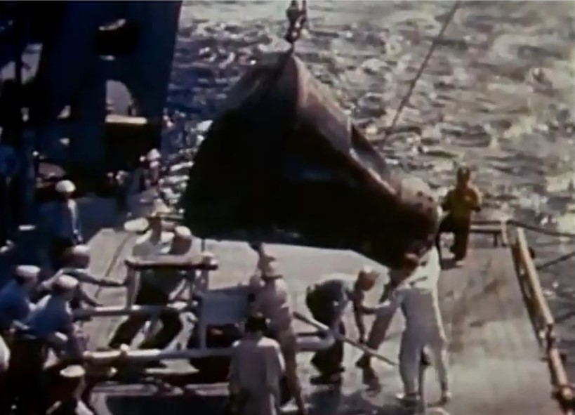 Gemini 2 capsule being hoisted aboard the USS Lake Champlain after recovery